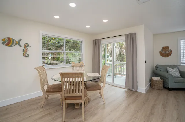 a dining room with furniture and wooden floor