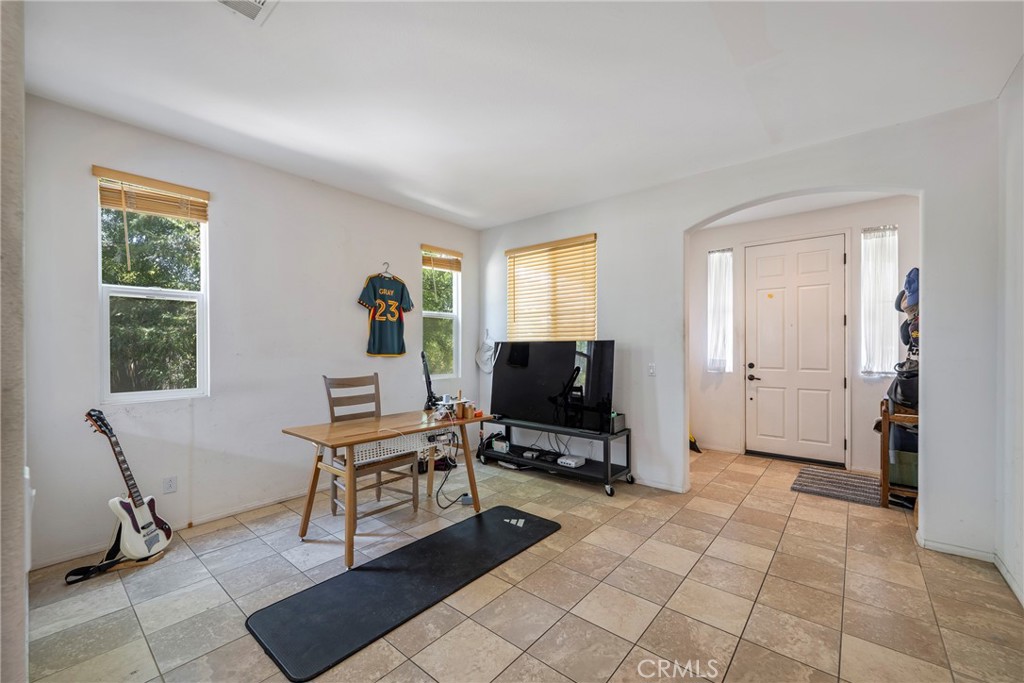 3819 St Austell Way Perris, CA 92571 - Photo 7 of 64 a view of a workspace with furniture and a window