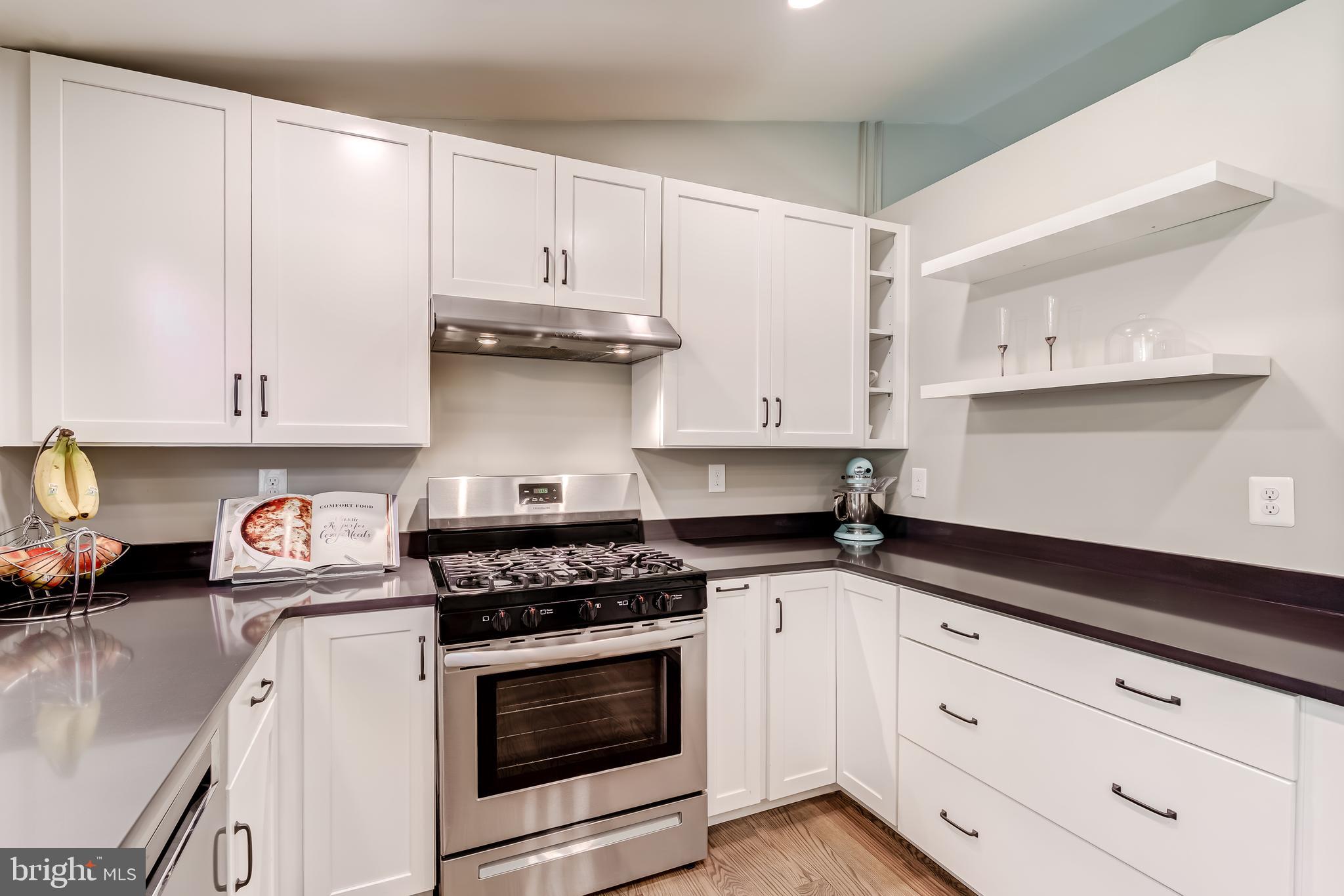 11926 Appling Valley Road Fairfax, VA 22030 - Photo 21 of 60 a kitchen with granite countertop white cabinets and appliances