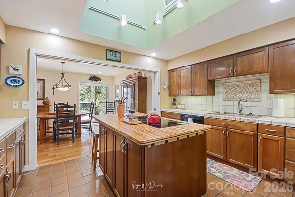a kitchen with a sink a stove and cabinets
