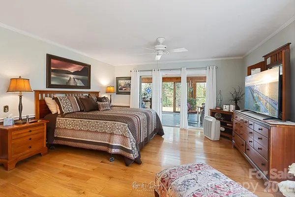 a bedroom with furniture and a flat screen tv