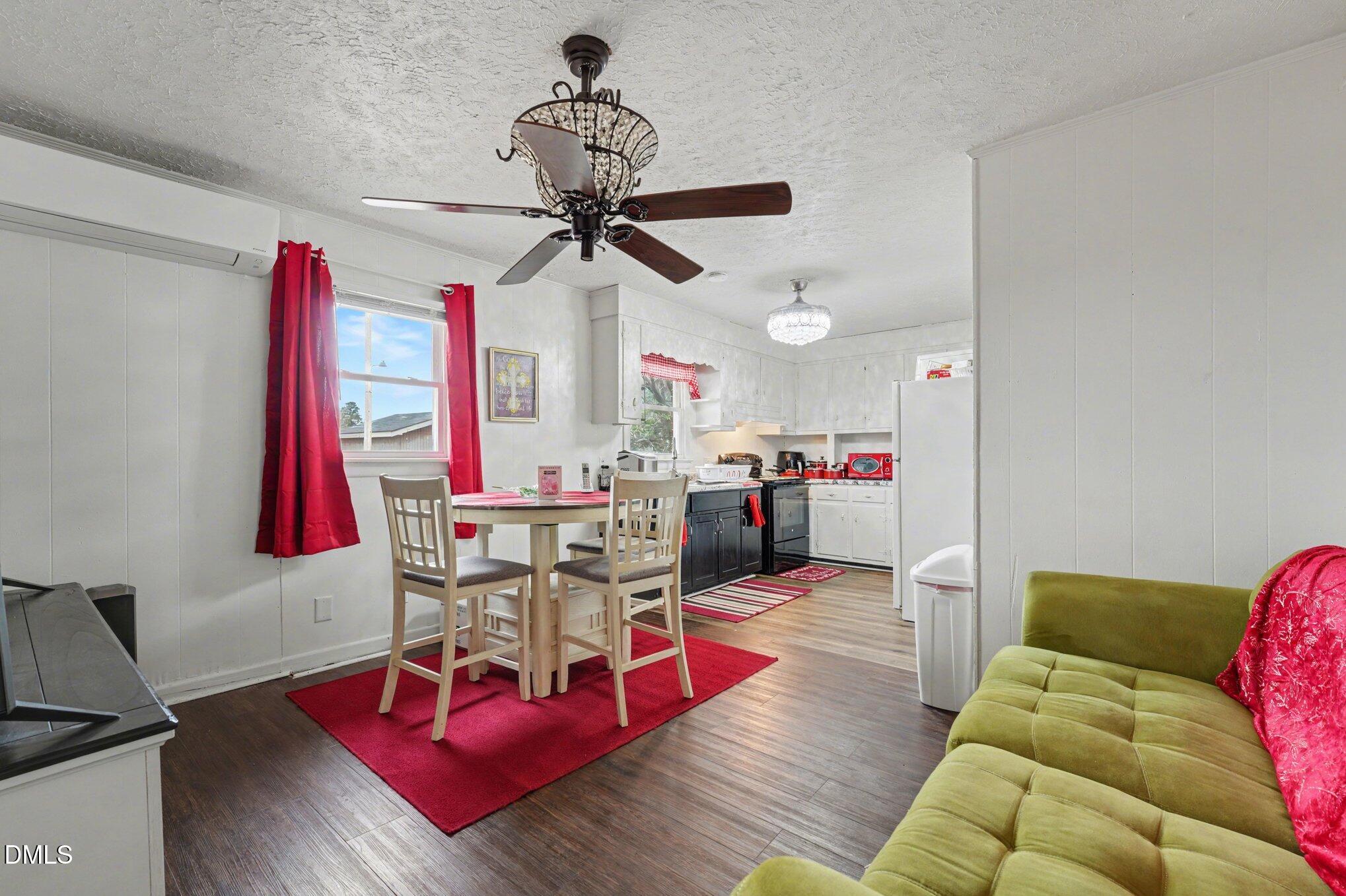 170 Flowers Road Mount Olive, NC 28365 - Photo 12 of 19 a living room with furniture a rug and a chandelier