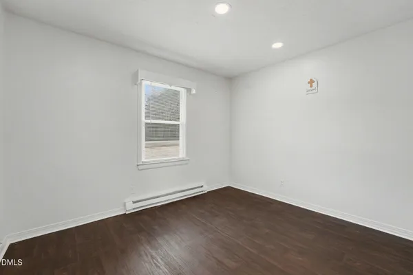 a backyard of a house with barbeque oven and glass windows