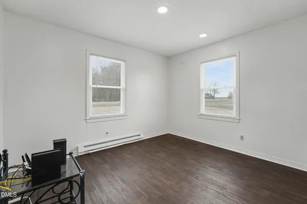 a view of a room with wooden floor and windows