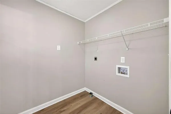 a view of a room with wooden floor