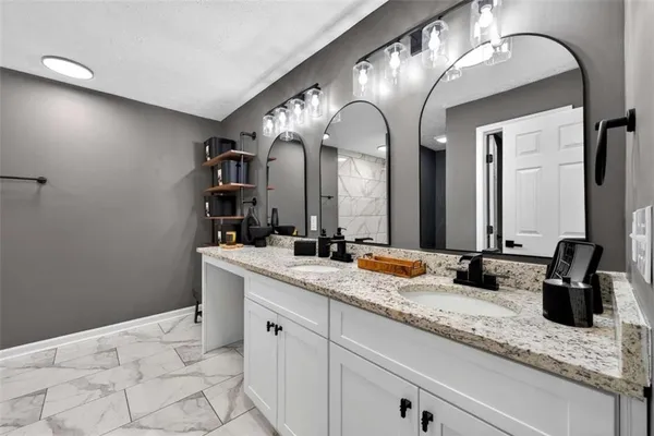 a bathroom with double sink and a mirror