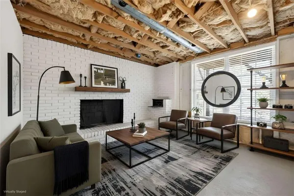 a living room with furniture a rug a fireplace