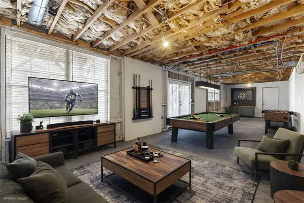 a living room with furniture a rug and a large window