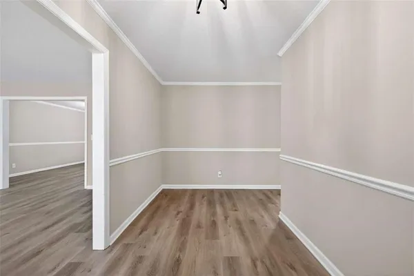 a view of a room with wooden floor