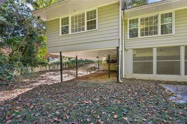 a front view of house with yard and trees around