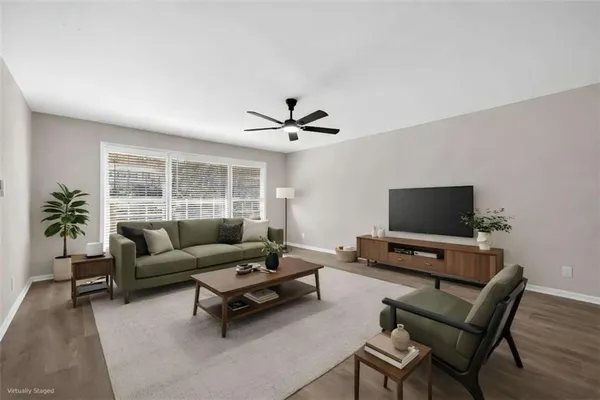 a living room with furniture and a flat screen tv