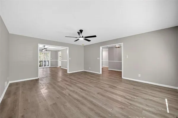a view of an empty room with wooden floor