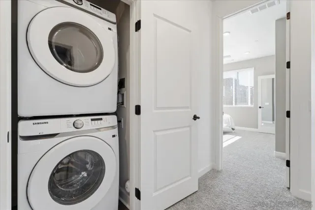 a view of a hallway with washer and dryer