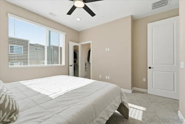 a bedroom with a large bed and a window