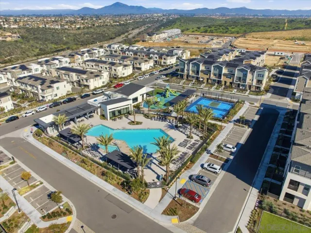 an aerial view of residential houses with outdoor space
