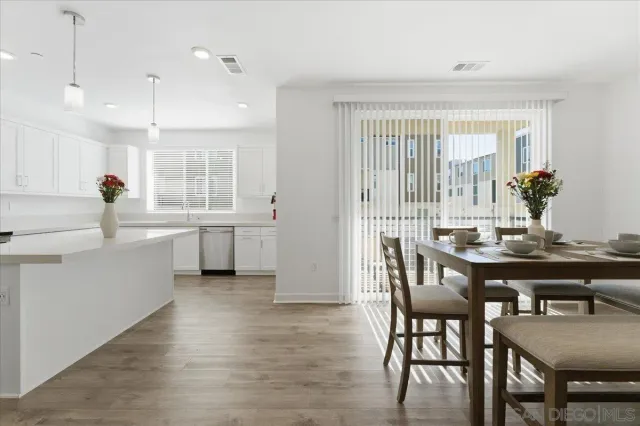 a view of a dining room with furniture and wooden floor