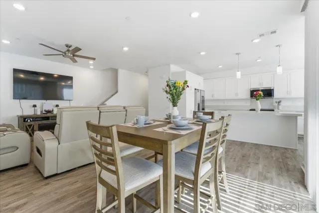 a view of a dining room with furniture and a flat screen tv