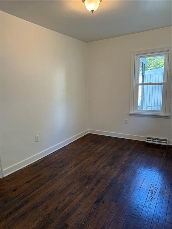 259 Rte 908 Natrona Heights, PA 15065 - Photo 12 of 29 a view of an empty room with wooden floor and a window