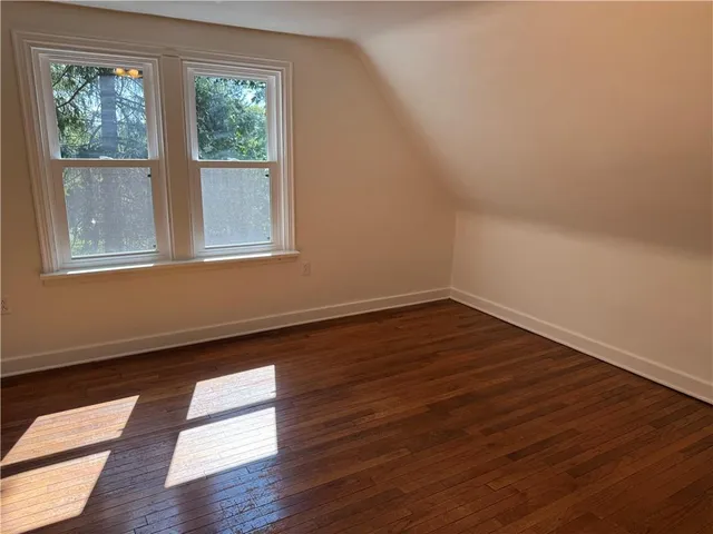 a view of wooden floor and windows in a room