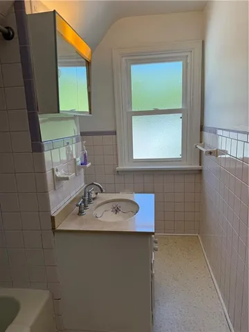 a white toilet sitting next to a white wall