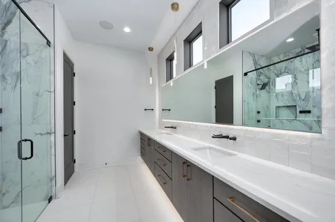 a view of a lake with a yard and a large tree