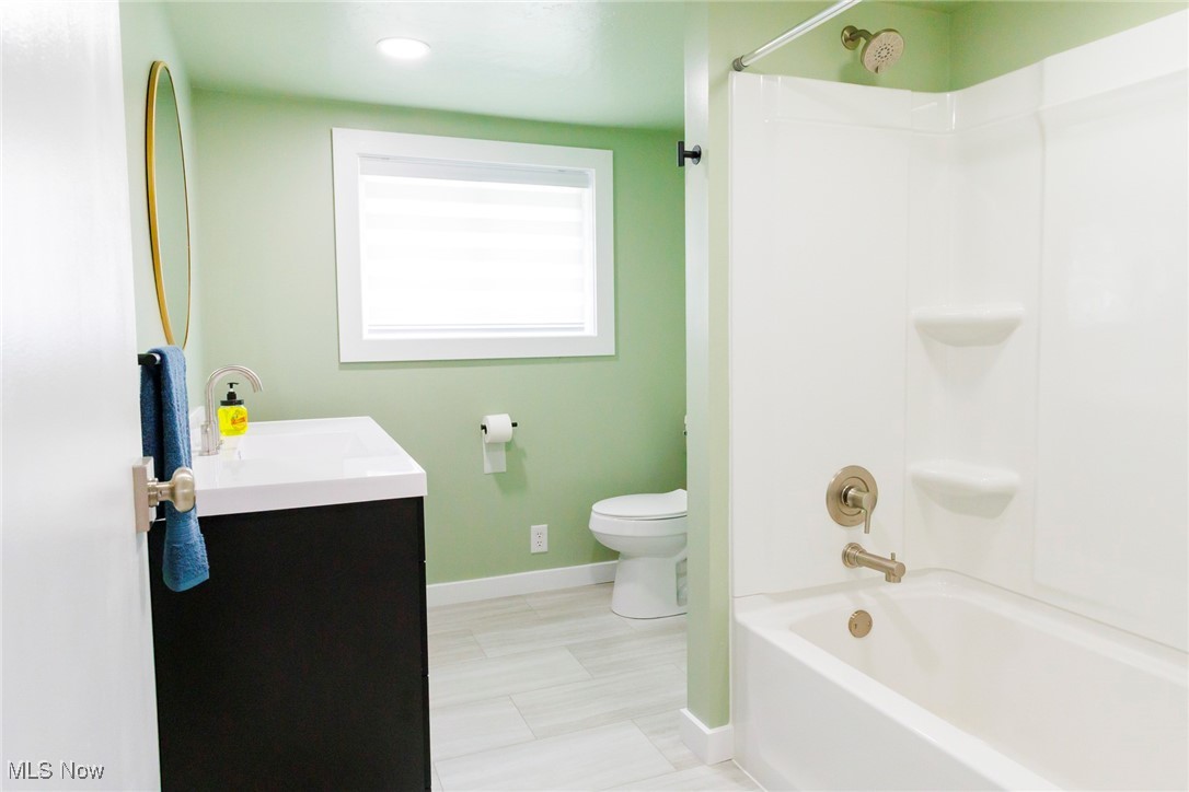 13239 Navarre Road Southwest Beach City, OH 44608 - Photo 9 of 48 Full bathroom featuring toilet, baseboards, vanity, bathing tub / shower combination, and recessed lighting