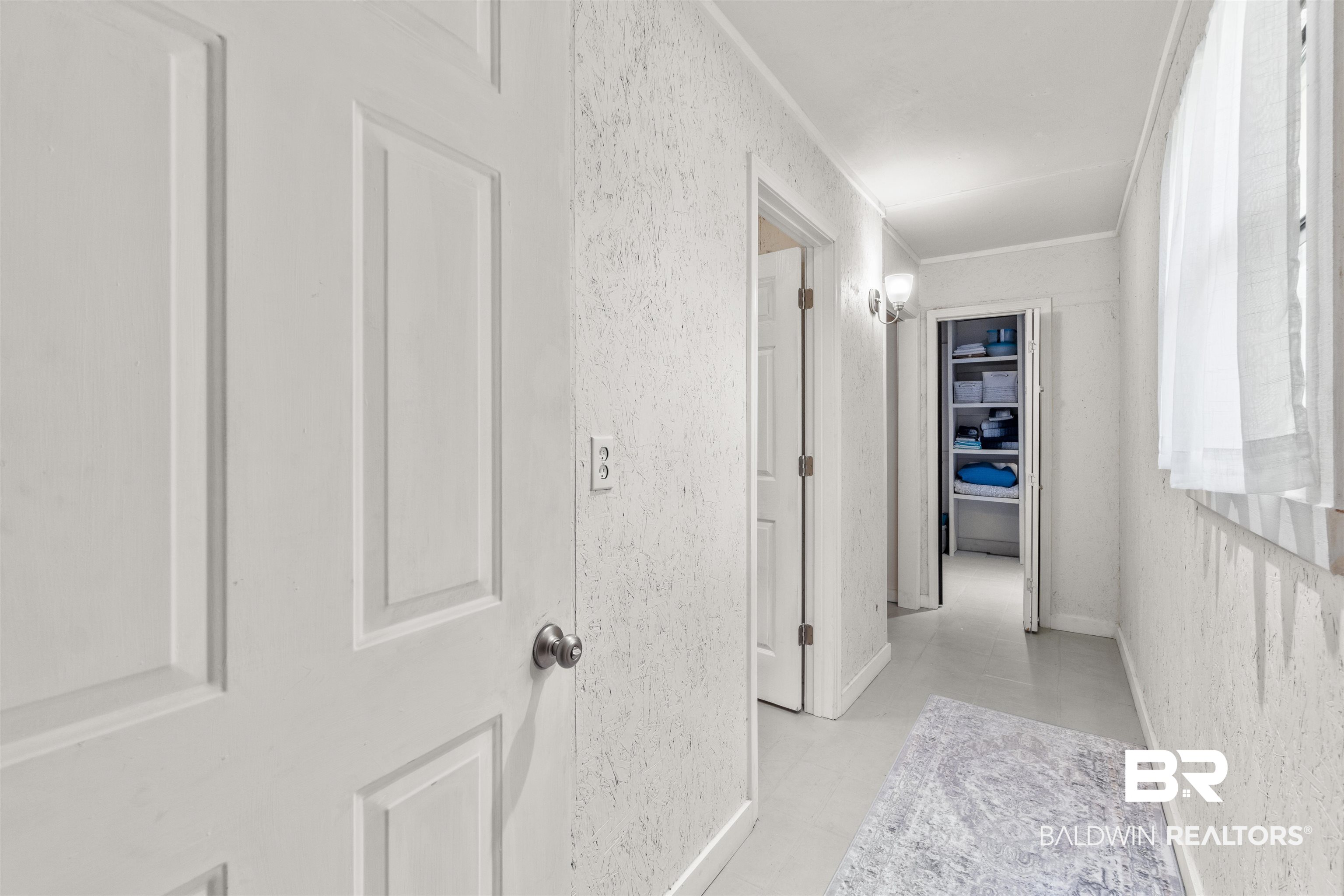 17595 River Road Summerdale, AL 36580 - Photo 19 of 29 Hallway with crown molding and a textured wall