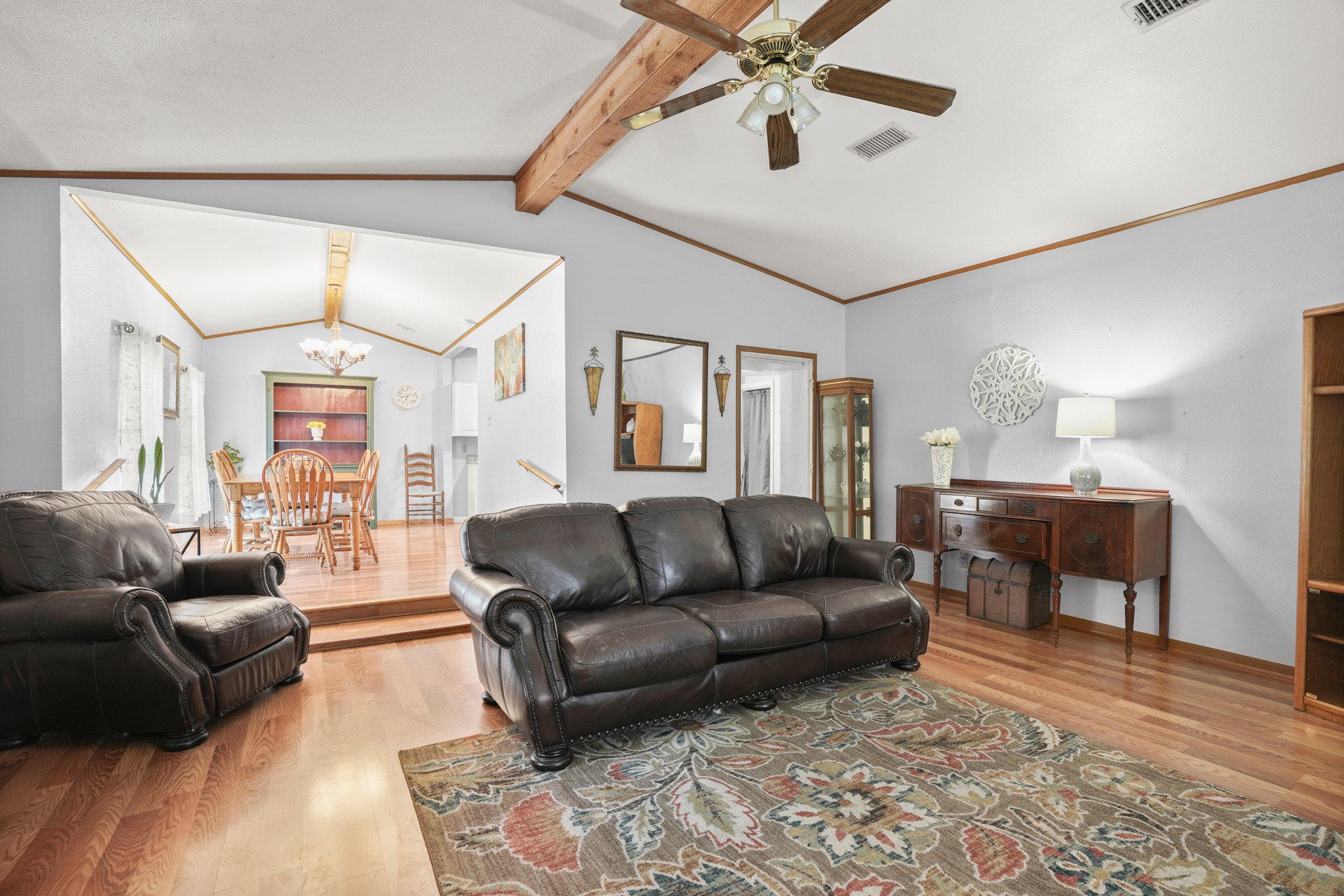 1908 Holly Street Austin, TX 78702 - Photo 3 of 22 Natural wood flooring complements vaulted ceilings and a ceiling fan for comfortable living.
