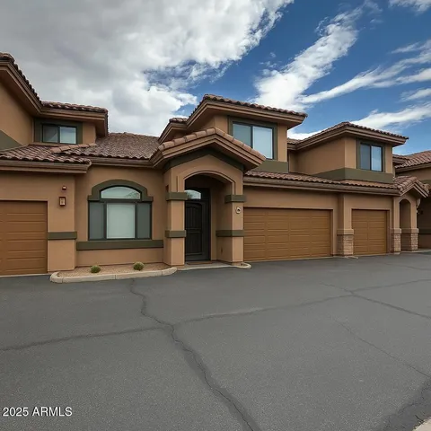 a view of a house with a garage and balcony