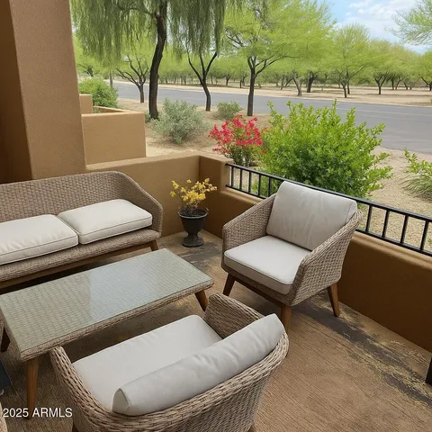 a balcony with furniture and a potted plant
