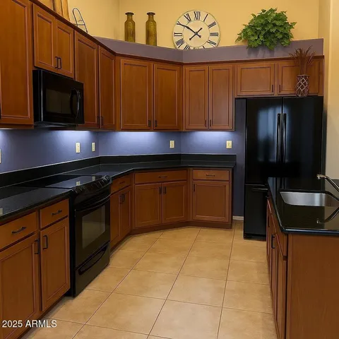 a kitchen with stainless steel appliances granite countertop a sink and a stove