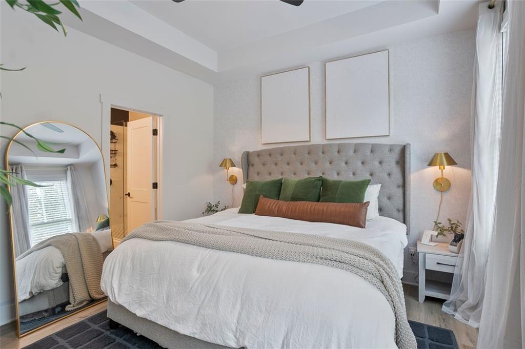 1081 Crest Circle Southeast Atlanta, GA 30312 - Photo 13 of 26 a bedroom with a bed and wooden floor