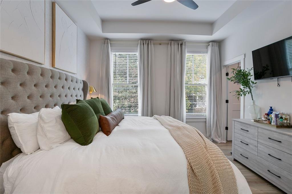 1081 Crest Circle Southeast Atlanta, GA 30312 - Photo 14 of 26 a bedroom with a bed and a flat tv screen on dresser