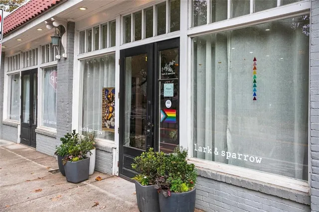 a view of a patio with table and chairs and floor to ceiling window