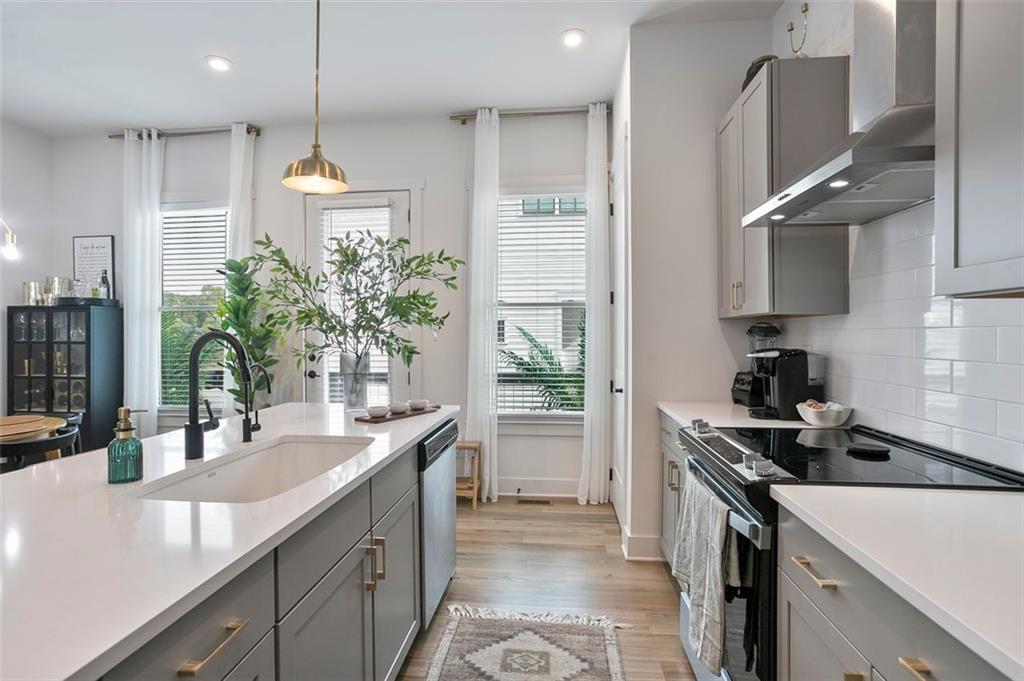 1081 Crest Circle Southeast Atlanta, GA 30312 - Photo 4 of 26 a kitchen with kitchen island granite countertop a sink stainless steel appliances and cabinets