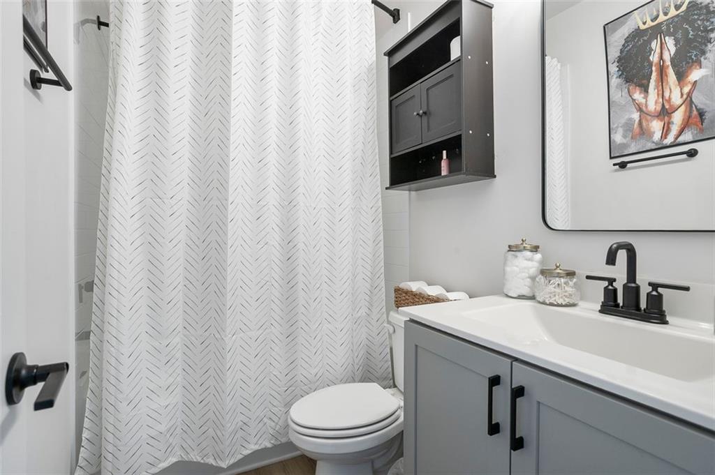 1081 Crest Circle Southeast Atlanta, GA 30312 - Photo 9 of 26 a bathroom with a toilet sink and mirror