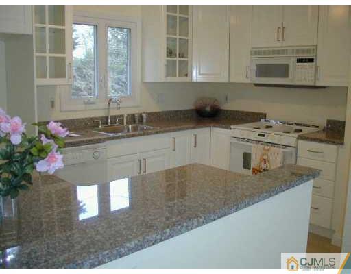 33 Allwood Road East Brunswick, NJ 08816 - Photo 2 of 8 a kitchen with stainless steel appliances granite countertop a sink stove and cabinets