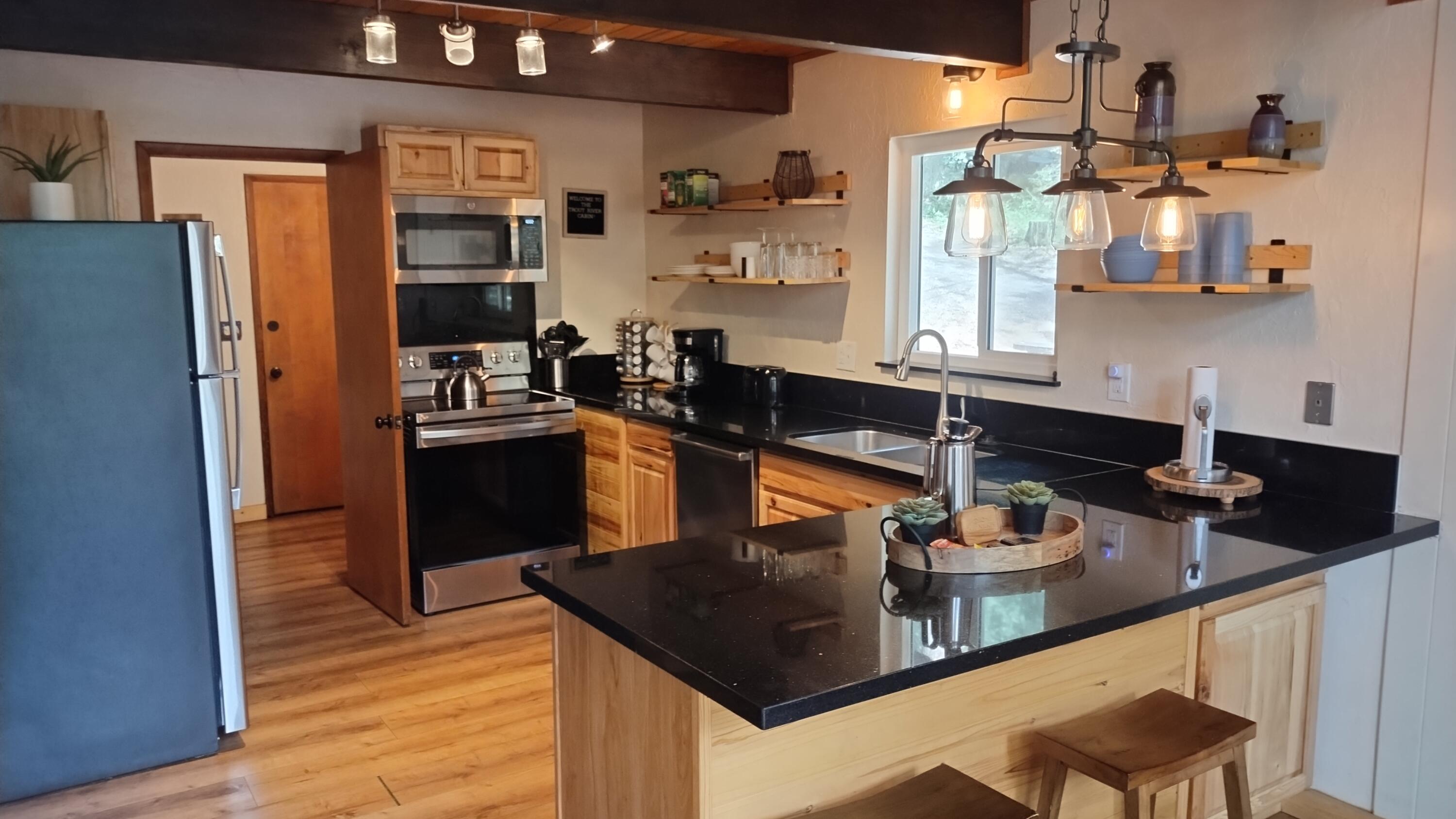 1693 Forest Rte 21S94 Camp Nelson, CA 93265 - Photo 14 of 86 a kitchen with stainless steel appliances granite countertop a sink dishwasher stove and refrigerator with wooden floor