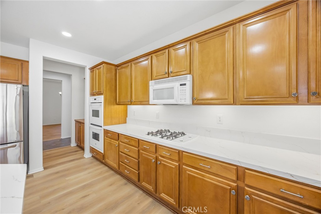 8710 Windmill Place Riverside, CA 92508 - Photo 18 of 66 a kitchen with stainless steel appliances granite countertop a stove a sink and a refrigerator