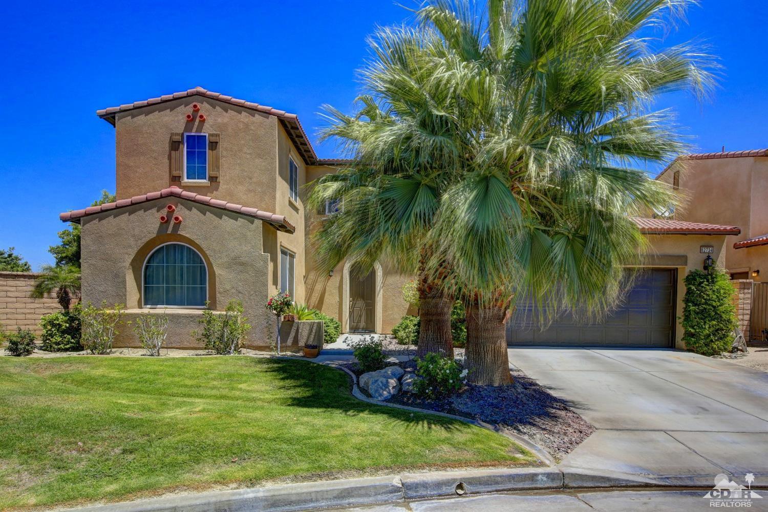 82734 Mount Riley Drive Indio, CA 92203 - Photo 1 of 26 a front view of a house with garden