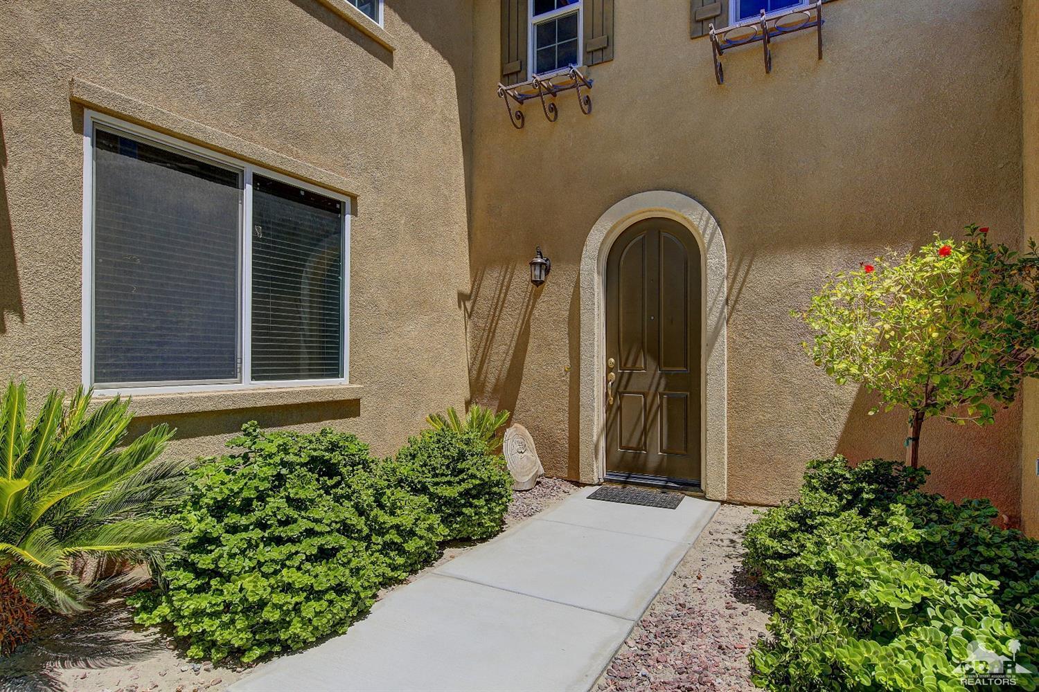 82734 Mount Riley Drive Indio, CA 92203 - Photo 2 of 26 a front view of a house with a yard