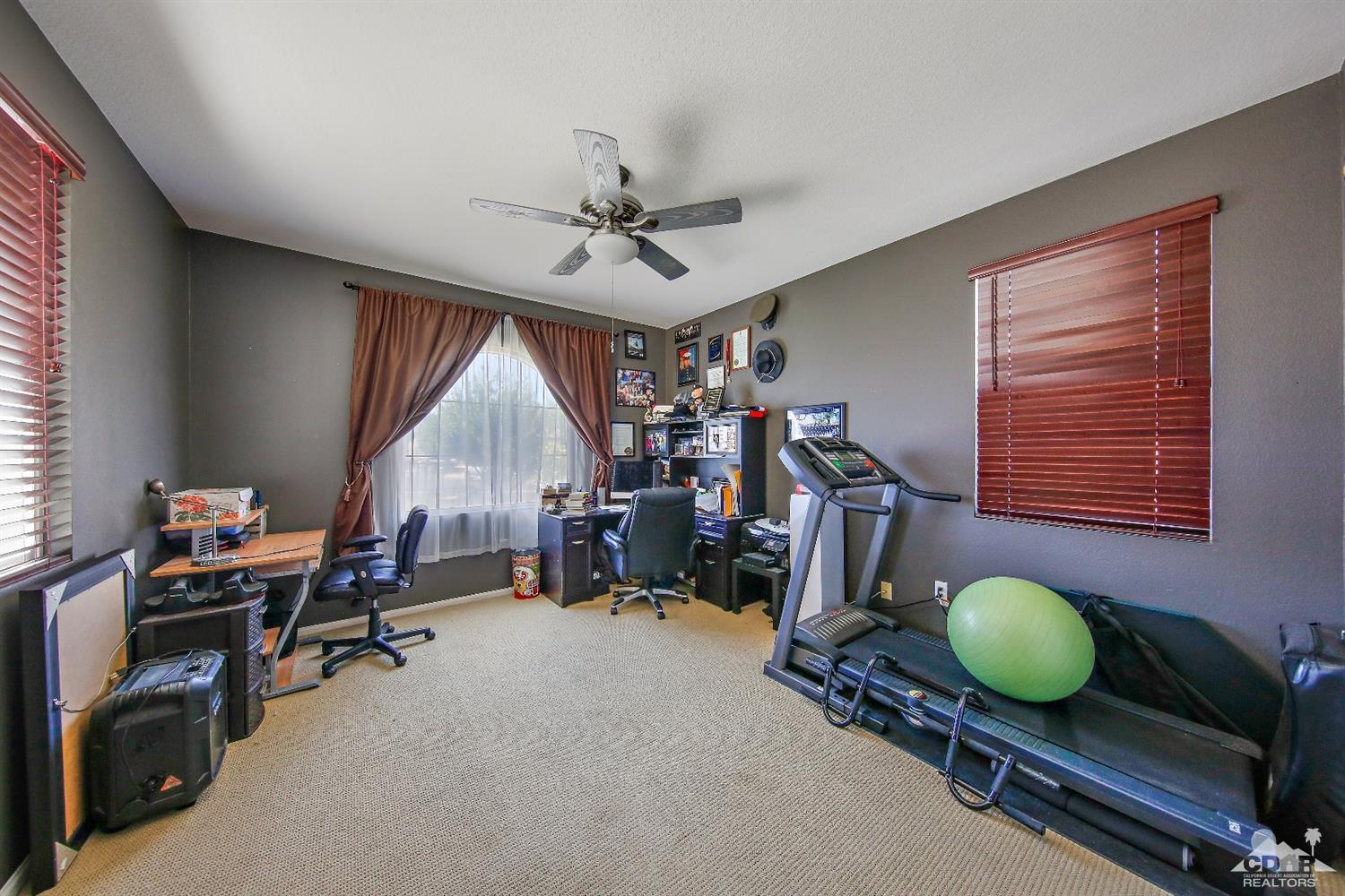 82734 Mount Riley Drive Indio, CA 92203 - Photo 12 of 26 a room with gym equipment and a large window