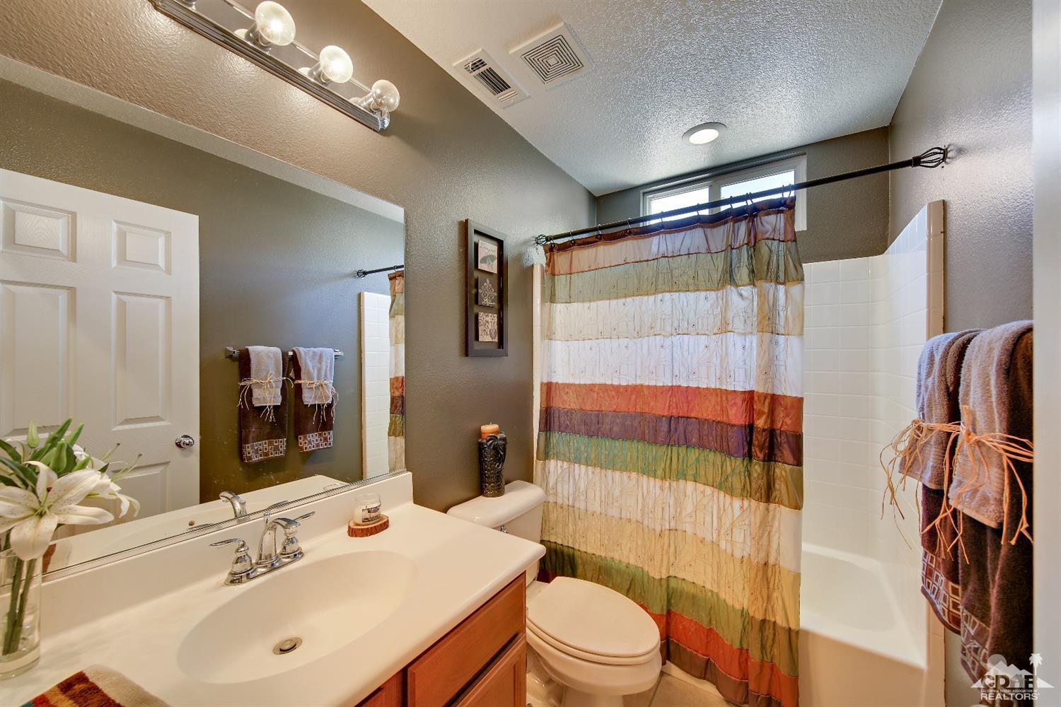 82734 Mount Riley Drive Indio, CA 92203 - Photo 13 of 26 a bathroom with a sink toilet and shower