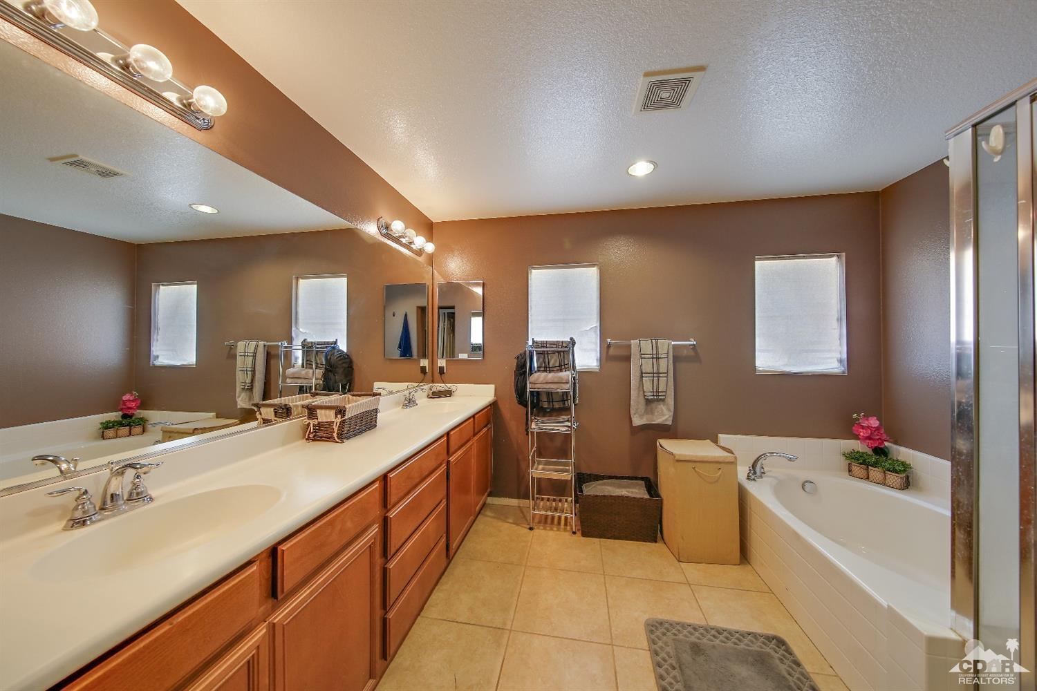 82734 Mount Riley Drive Indio, CA 92203 - Photo 16 of 26 a kitchen with counter top space sink stove and refrigerator