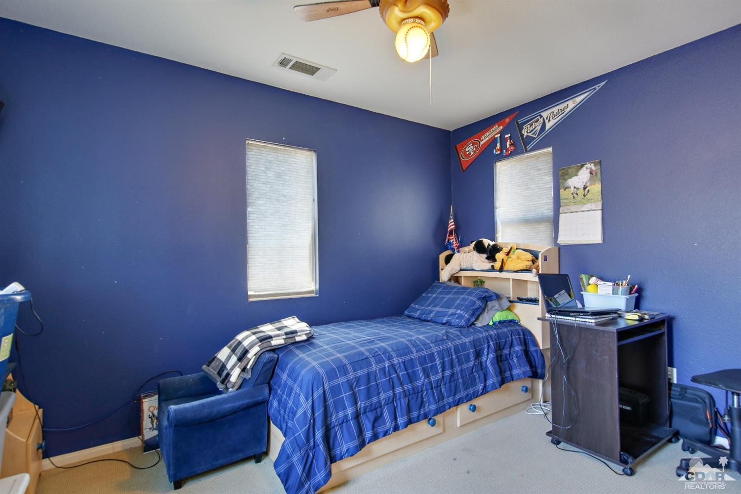 82734 Mount Riley Drive Indio, CA 92203 - Photo 20 of 26 a bedroom with a bed and a window