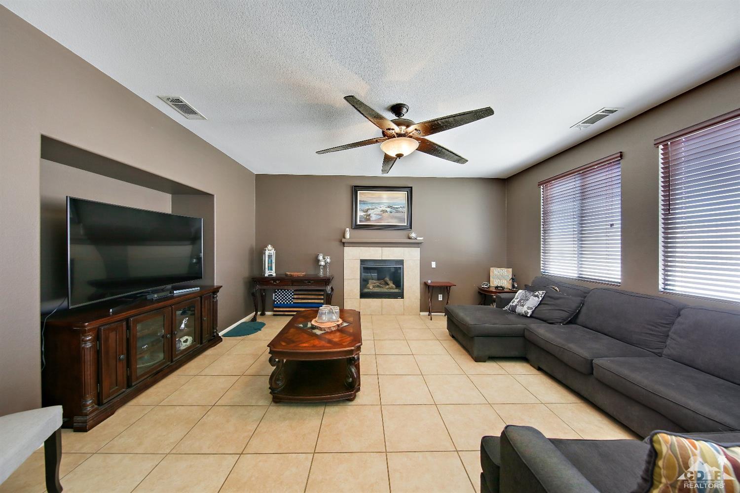 82734 Mount Riley Drive Indio, CA 92203 - Photo 4 of 26 a living room with furniture and a flat screen tv