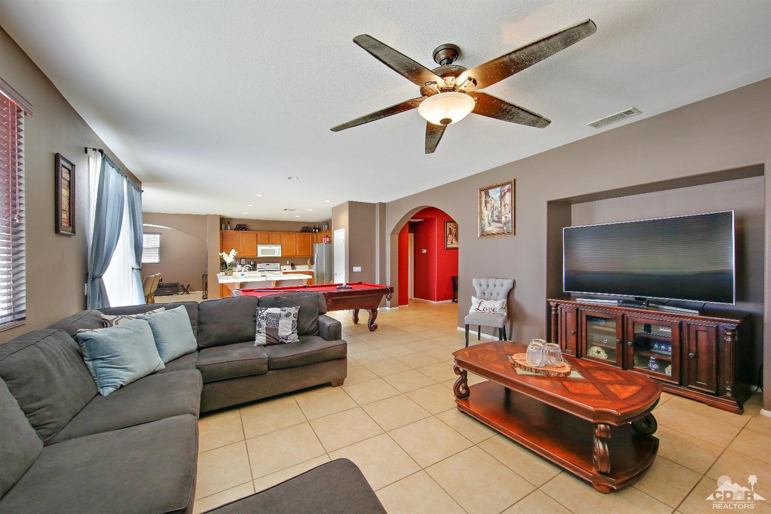 82734 Mount Riley Drive Indio, CA 92203 - Photo 5 of 26 a living room with furniture and a flat screen tv