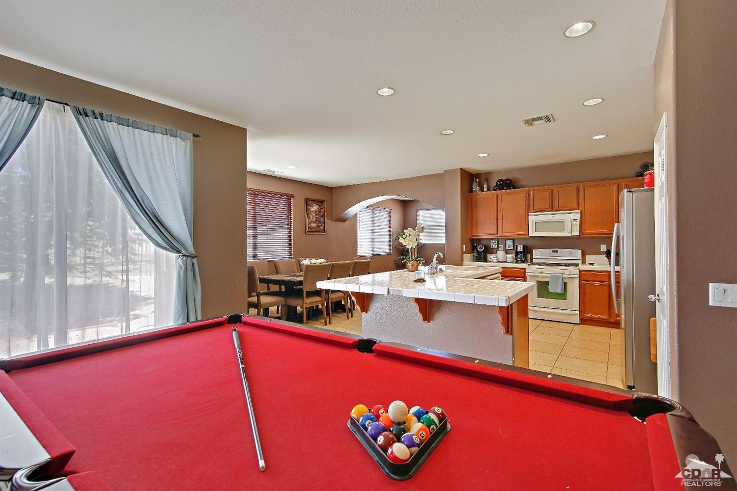 82734 Mount Riley Drive Indio, CA 92203 - Photo 6 of 26 a large kitchen with lots of counter top space and stainless steel appliances