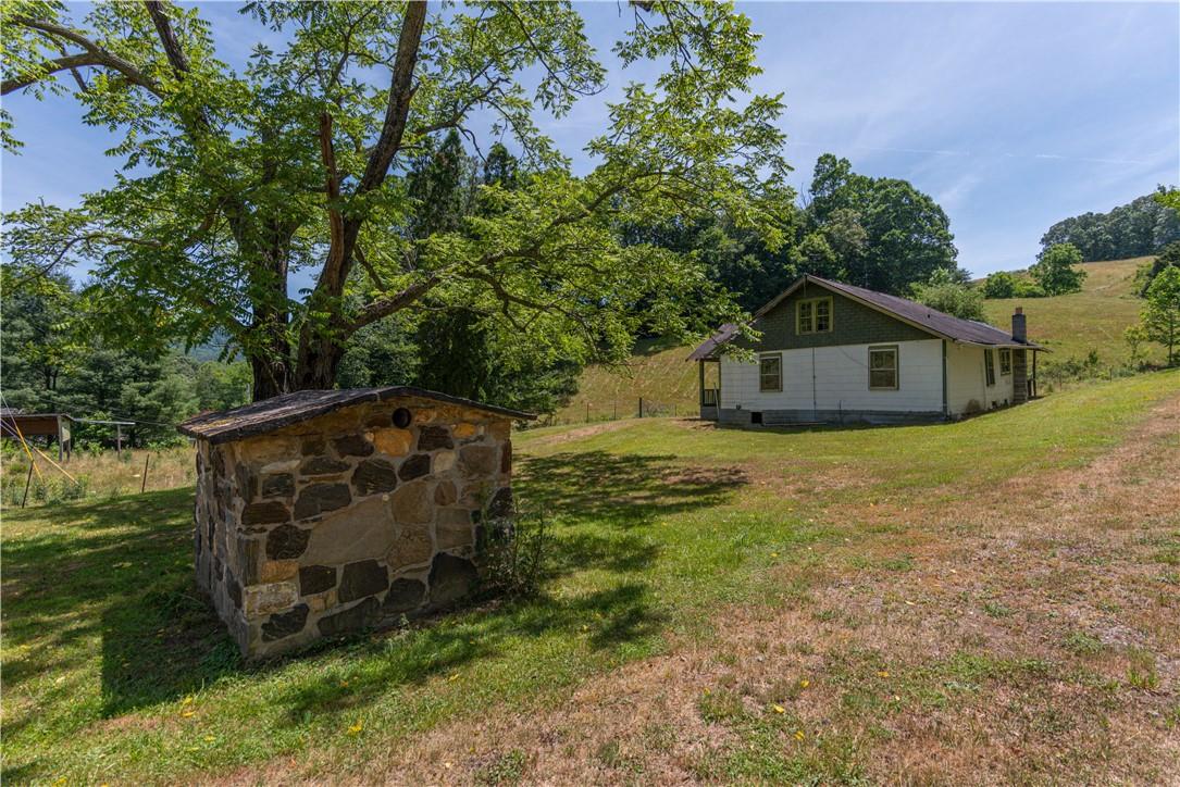2854 Rabbit Skin Road Waynesville, NC 28785 - Photo 23 of 29 a view of a tiny house with yard and a wooden fence