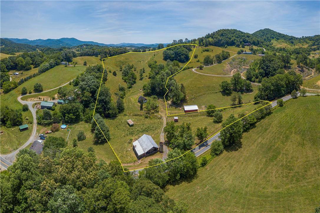 2854 Rabbit Skin Road Waynesville, NC 28785 - Photo 29 of 29 an aerial view of green landscape with trees houses and mountain view